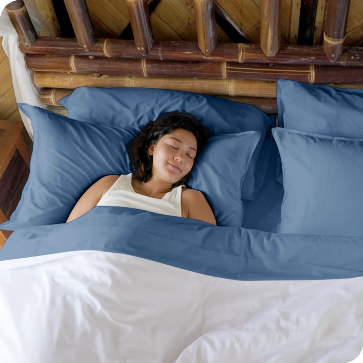 A woman sleeping in a bed made with bamboo sheets