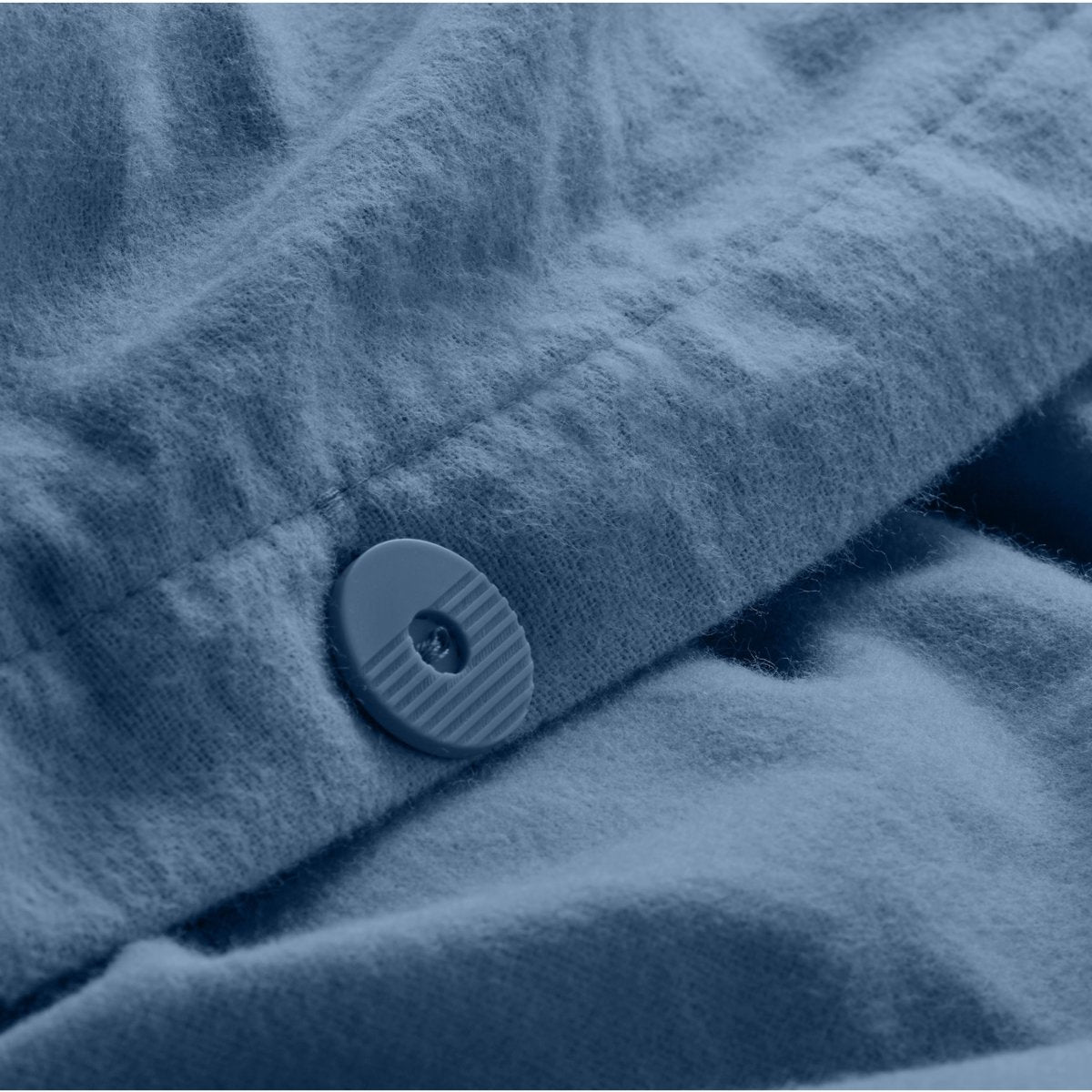 Close up of the button closure on a flannel duvet cover