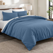 Flannel duvet cover set on a bed in a bedroom with a lamp and plant in the background.