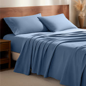Flannel bedding set on a bed with a wooden headboard and side table