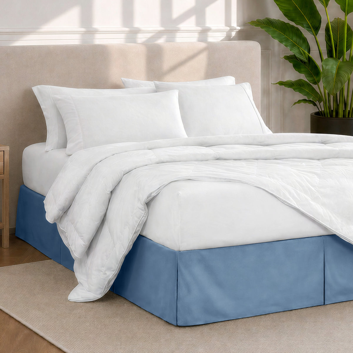 A modern bedroom with a bed skirt, comforter and sheets on the bed