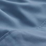 A close-up of microfiber fabric with soft folds and a visible stitched seam.