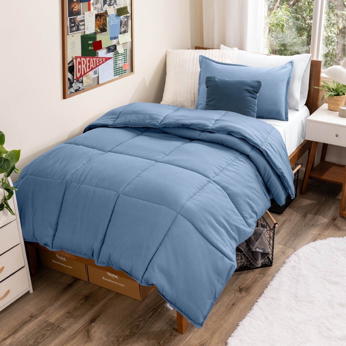 Comforter set on a bed in a bedroom with a window and decor.