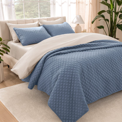Bedroom showing coverlet set laying on the bed with the quilt folded over on itself