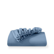 A fitted sheet folded neatly with the all around elastic showing