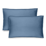 Two coronet blue pillow shams on pillows standing up with one behind the other