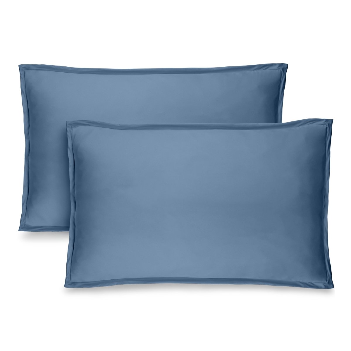 Two blue pillow shams on pillows standing up with one behind the other