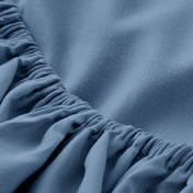 A close-up of a fitted sheet with elasticized edge.