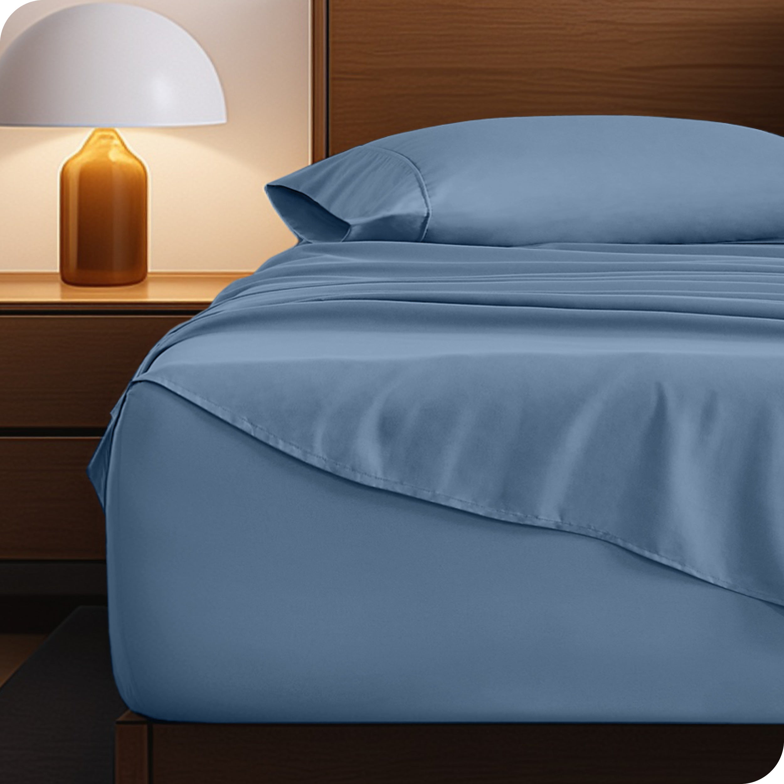 Microfiber bed sheets on a neatly made bed with a wooden headboard and nightstand.