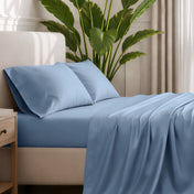 Ultra-soft sheets and pillowcases on a bed with a plant in the background