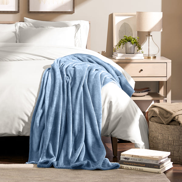 Microplush blanket draped over the corner of a bed