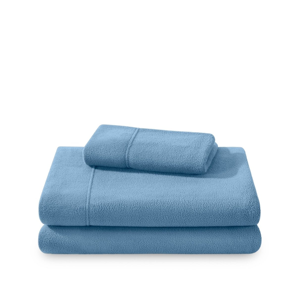 Polar fleece sheets and pillowcases folded and stacked on a white background