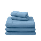 Polar fleece sheets and pillowcases folded and stacked on a white background