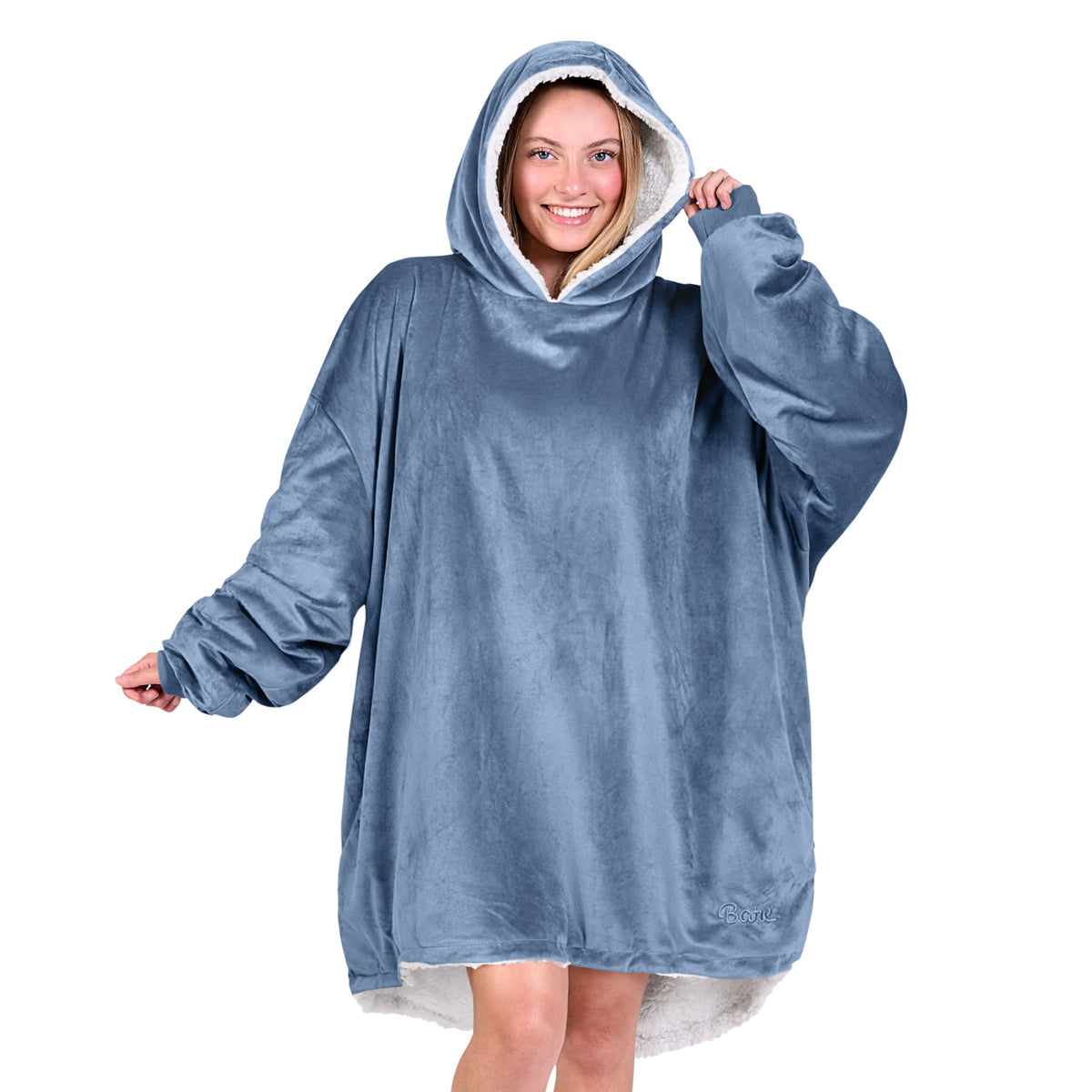 An adult with a hooded wearable blanket on