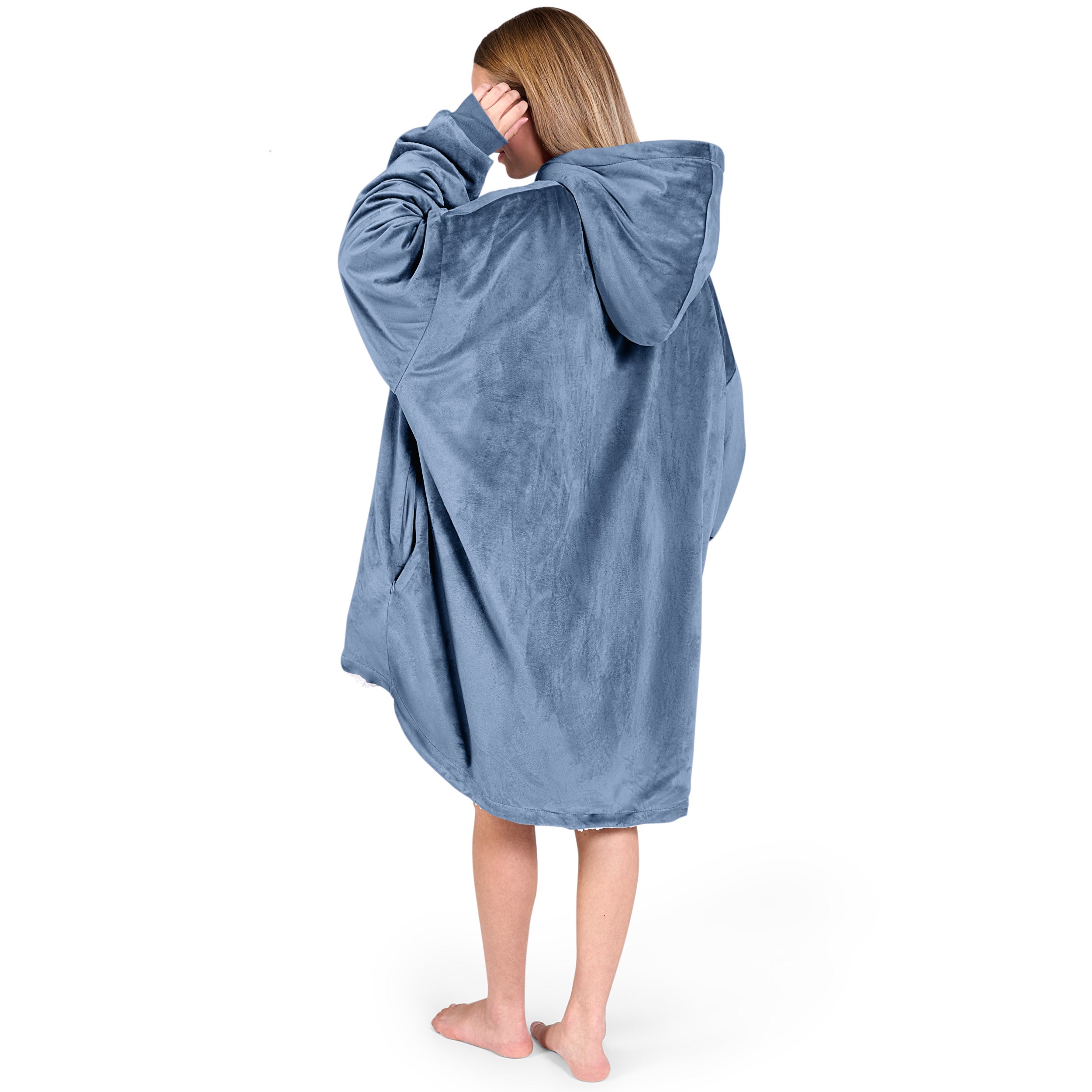 An adult with a sherpa wearable blanket on