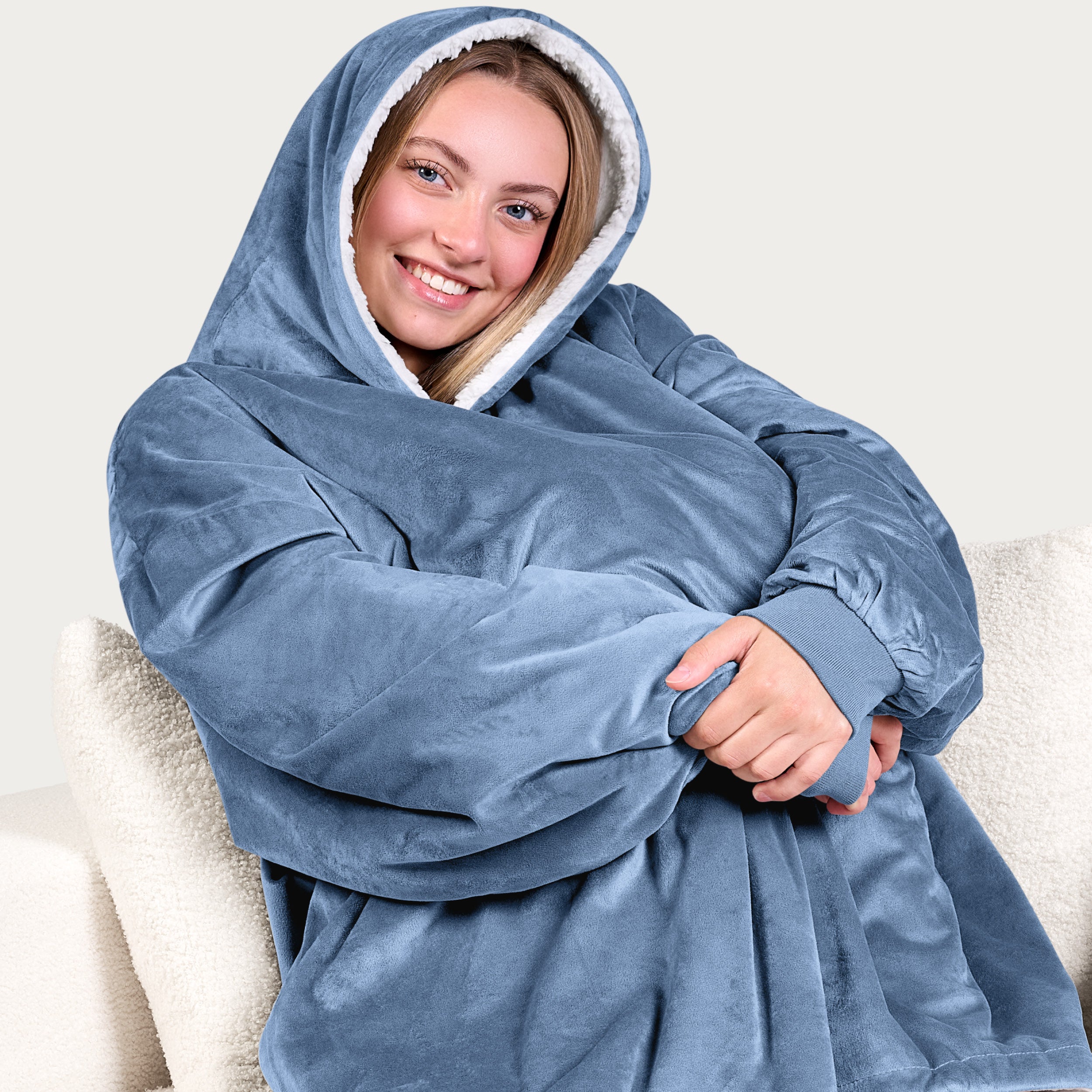 An adult with a sherpa wearable blanket on