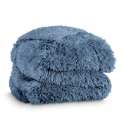 A shaggy faux fur blanket folded