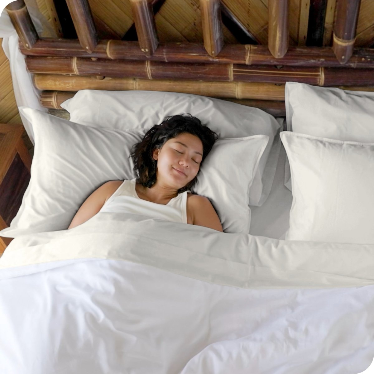 A woman sleeping in a bed made with bamboo sheets