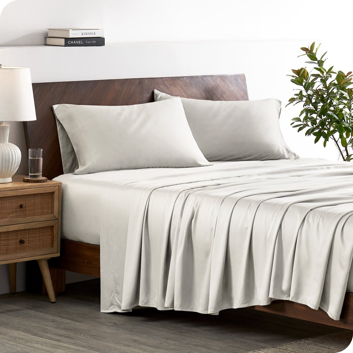 A stylish bed with bamboo sheets and pillowcases, showcasing a sophisticated and elegant bedroom setting.