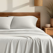 Bamboo sheets on a bed with a wooden headboard