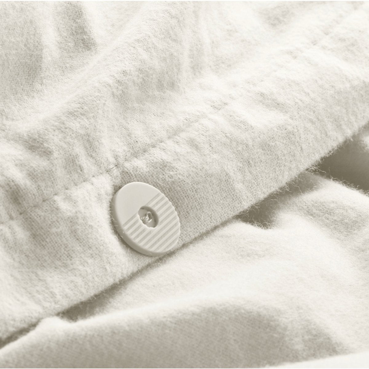 Close up of the button closure on a flannel duvet cover