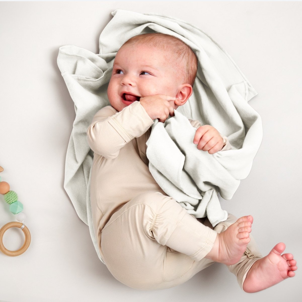 A baby lying on a flannel receiving blanket