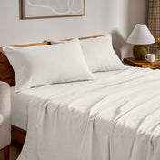 Flannel bed sheets and pillowcases on a bed in a bedroom setting.