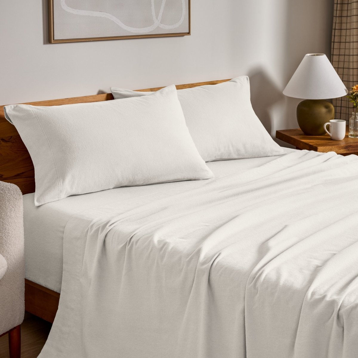 Flannel bed sheets and pillowcases on a bed in a bedroom setting.