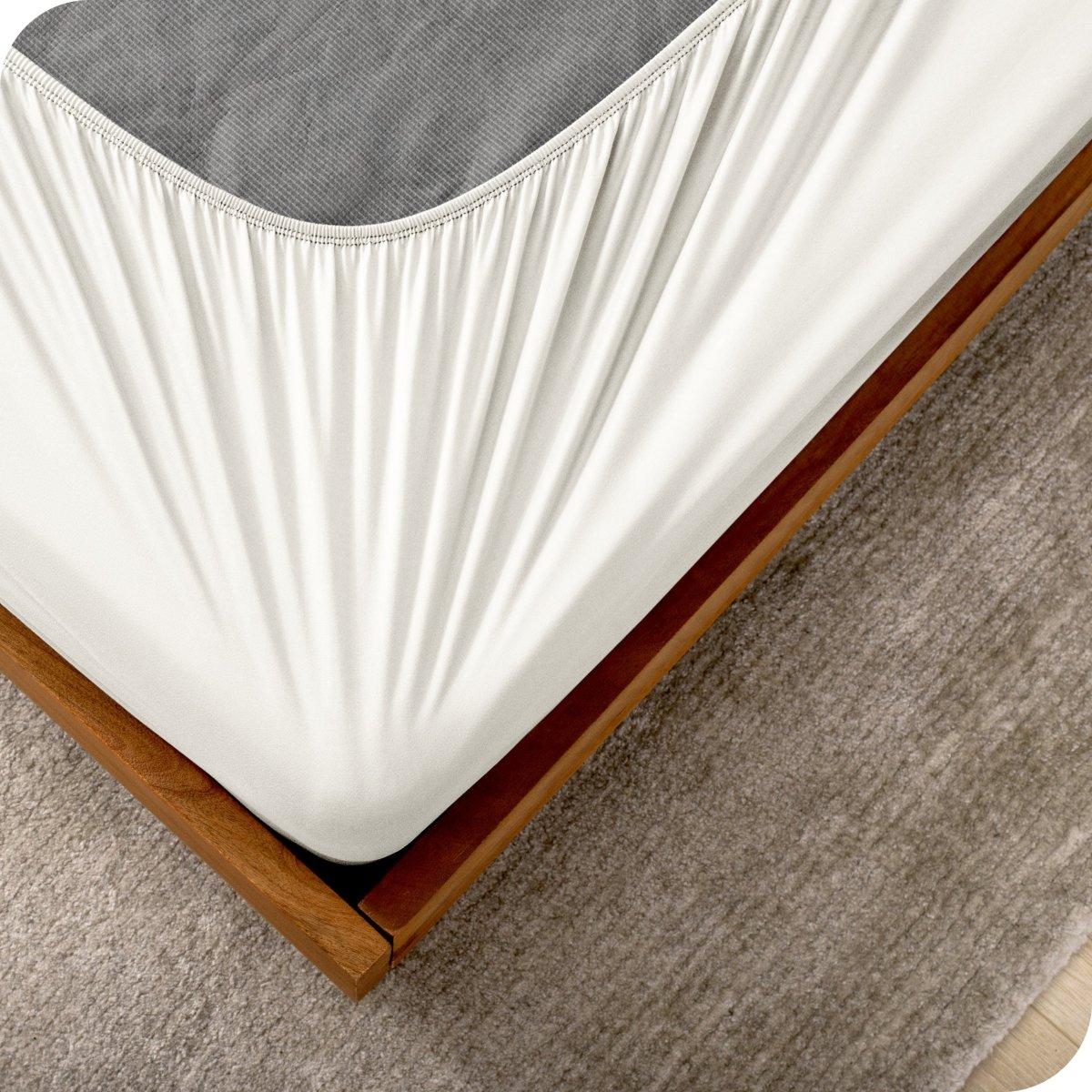 The corner of a box spring with a cover on it