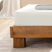 Close up of the corner of a bed frame with a cover box spring 