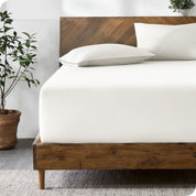 A bed with a fitted sheet and matching pillowcases