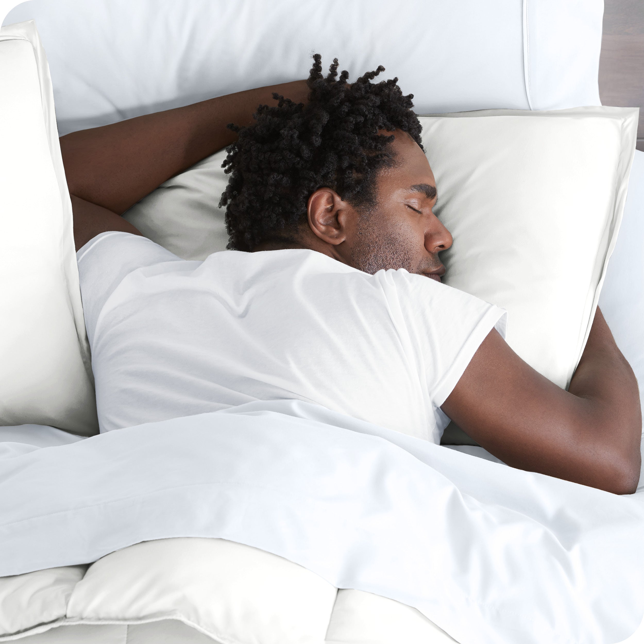 A man is sleeping with his head resting on a pillow covered with a microfiber pillow sham