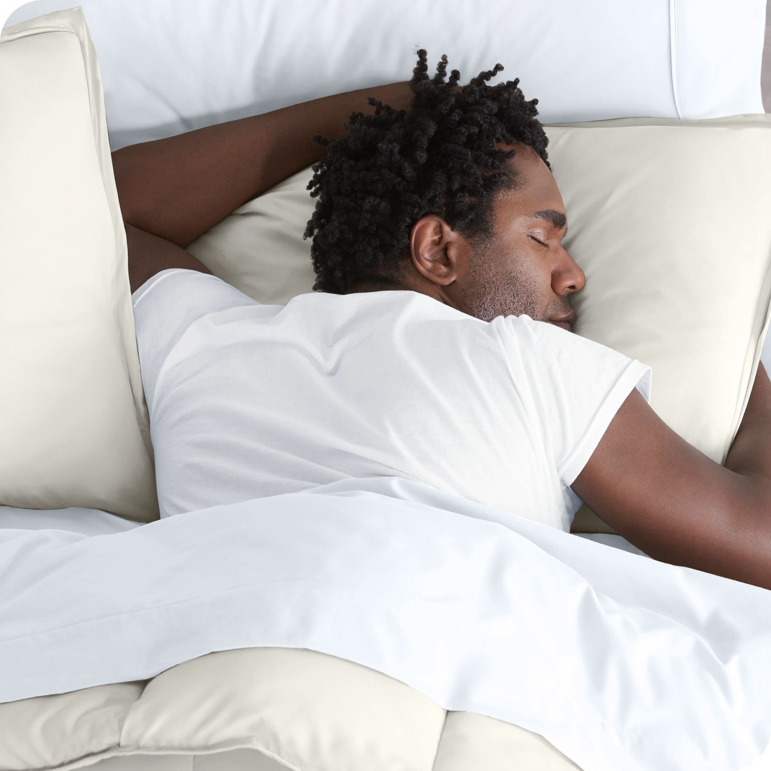 Man sleeping with his head resting on a pillow sham