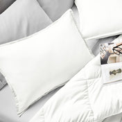 Microfiber pillow sham set on a bed with a magazine on top of the comforter.