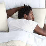 Man sleeping with his head resting on a pillow sham