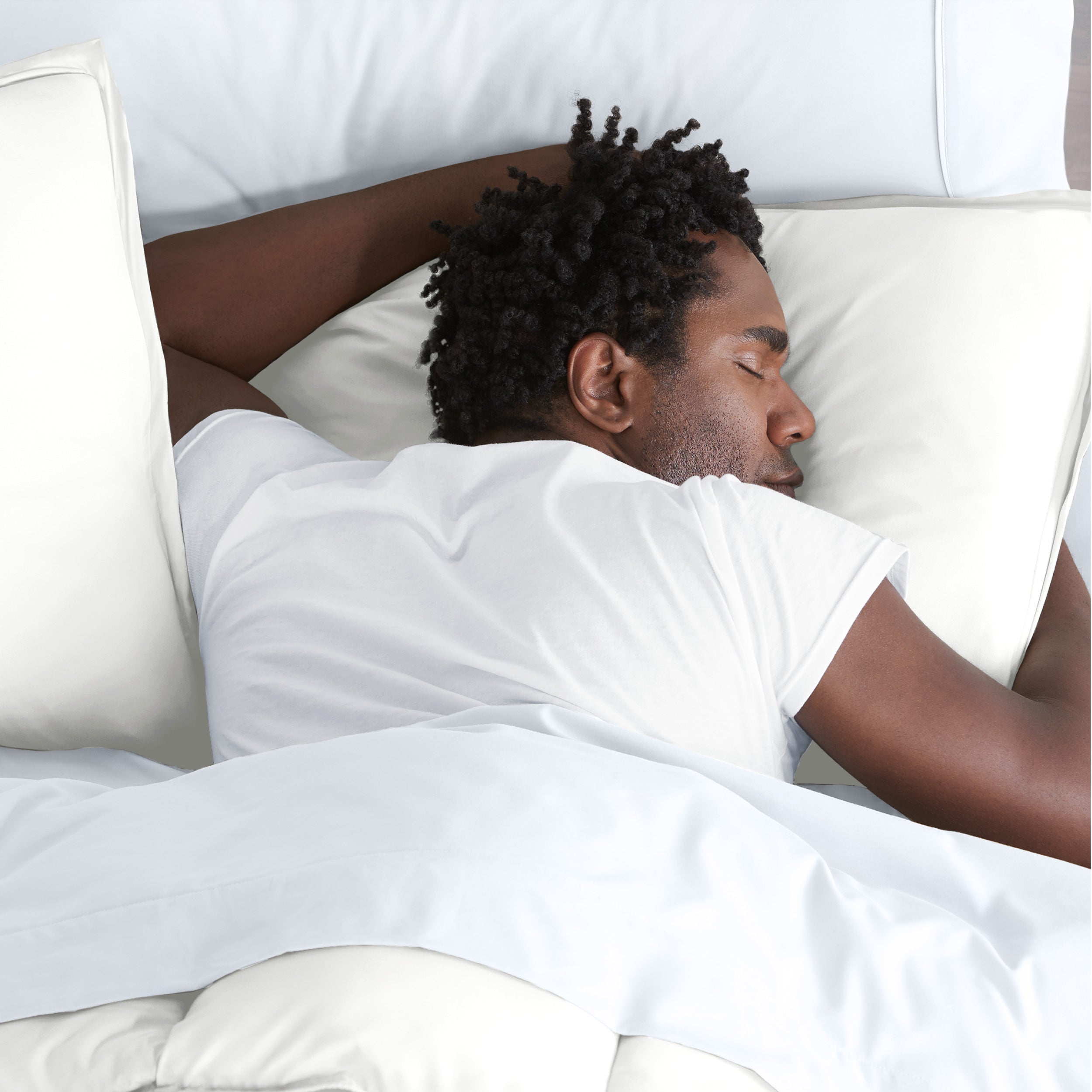 Man sleeping with his head resting on a pillow sham