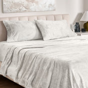 Microplush sheet set on a bed.