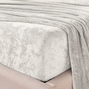 Close-up of the corner of a bed made with microplush sheets