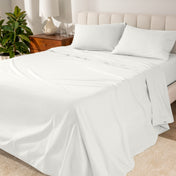 Percale sheets on a bed with a cream colored frame and headboard