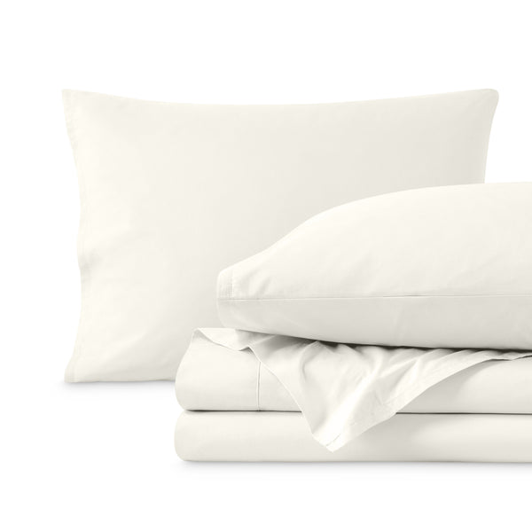 Percale sheets folded and matching pillowcases with pillows in them