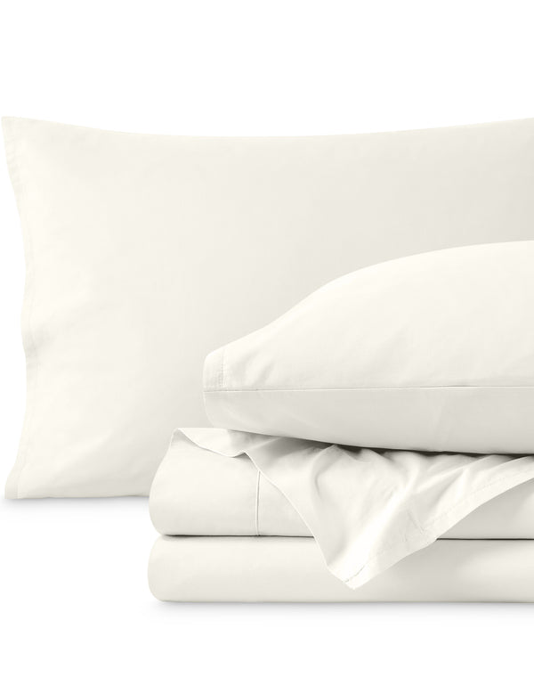 Percale sheets folded and matching pillowcases with pillows in them