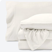 Fleece sheets folded neatly and stacked with pillows inside the pillowcases