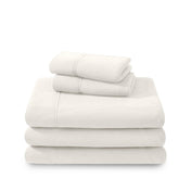 Polar fleece sheets and pillowcases folded and stacked on a white background