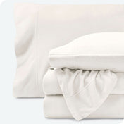 Fleece sheets folded neatly and stacked with pillows inside the pillowcases