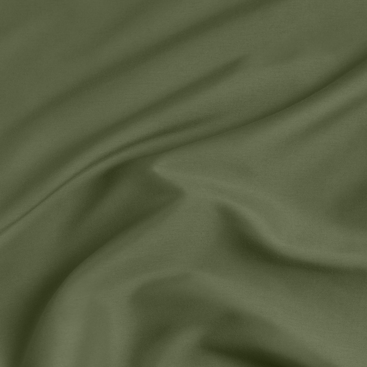 A close-up of a fitted sheet with a label printed with the word 'BOTTOM' in white.