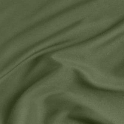 A close-up of a fitted sheet with a label printed with the word 'BOTTOM' in white.