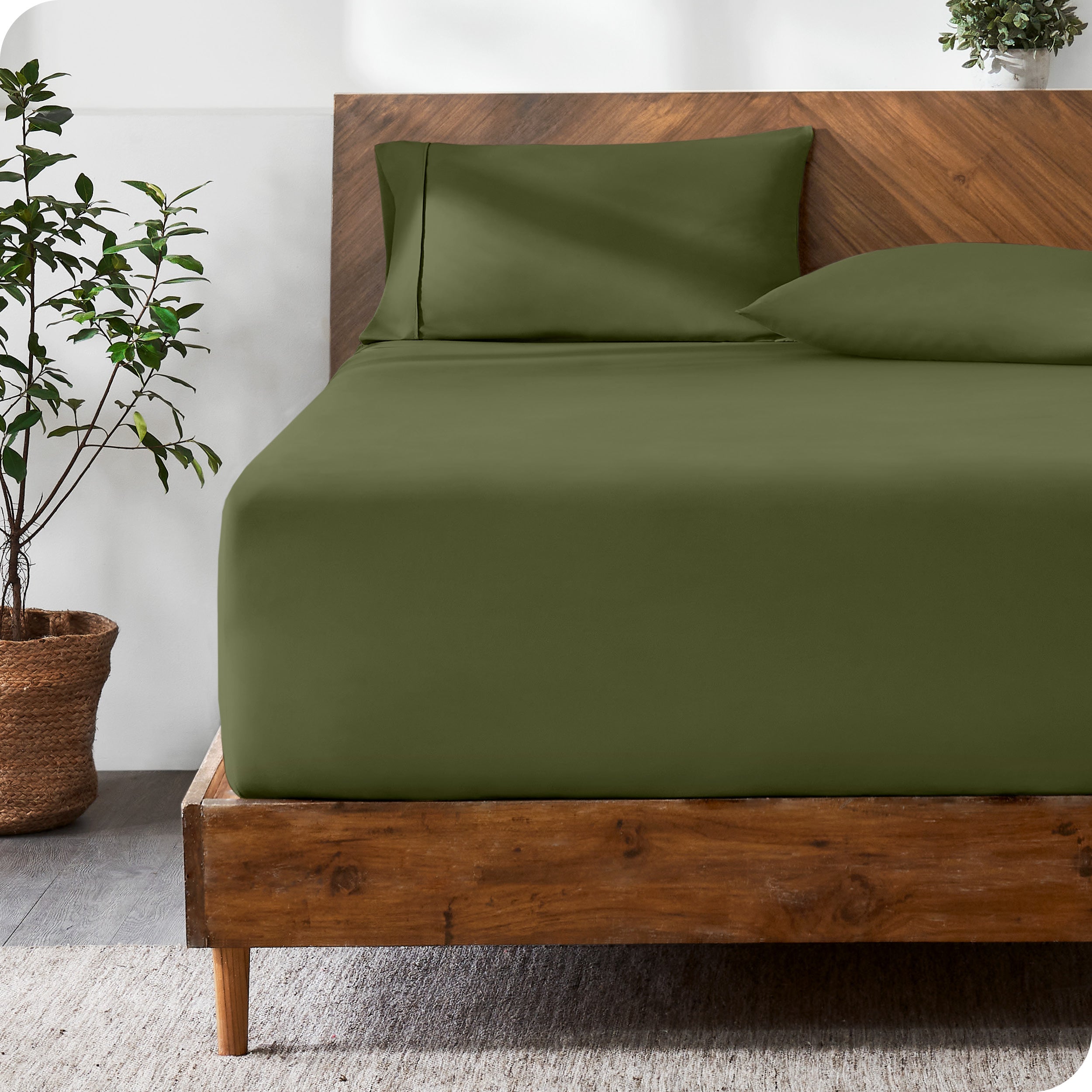 Wooden bed with ultra soft bedding in a minimalistic room.