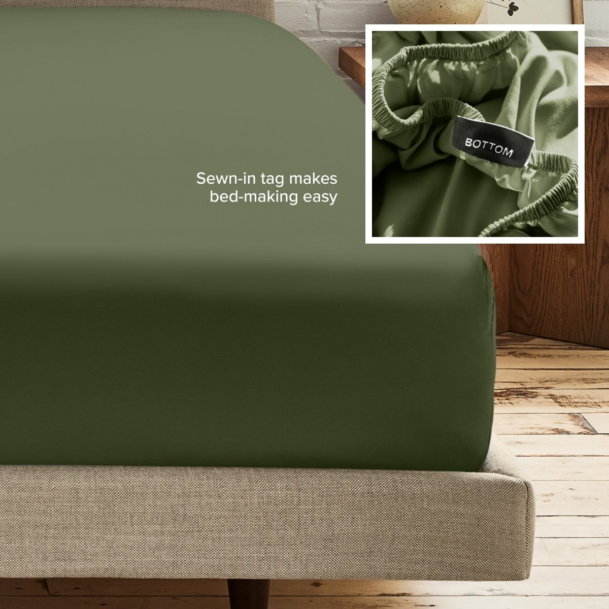 A fitted bed sheet on a bed frame with a small inset close-up of the elastic and a sewn-in tag labeled BOTTOM. White text on the sheet reads, 'Sewn-in tag makes bed-making easy.