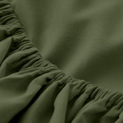 A close-up of a fitted sheet with elasticized edge.