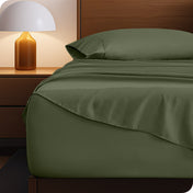 Microfiber bed sheets on a neatly made bed with a wooden headboard and nightstand.